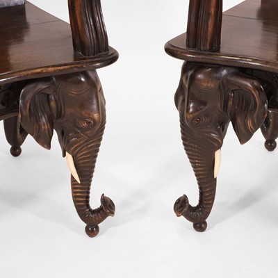 Lot 41 - A pair of carved linden wood Black Forest elbow chairs