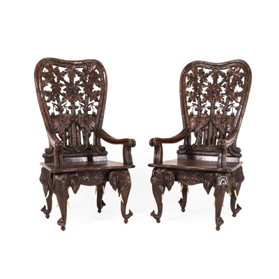 Lot 41 - A pair of carved linden wood Black Forest elbow chairs