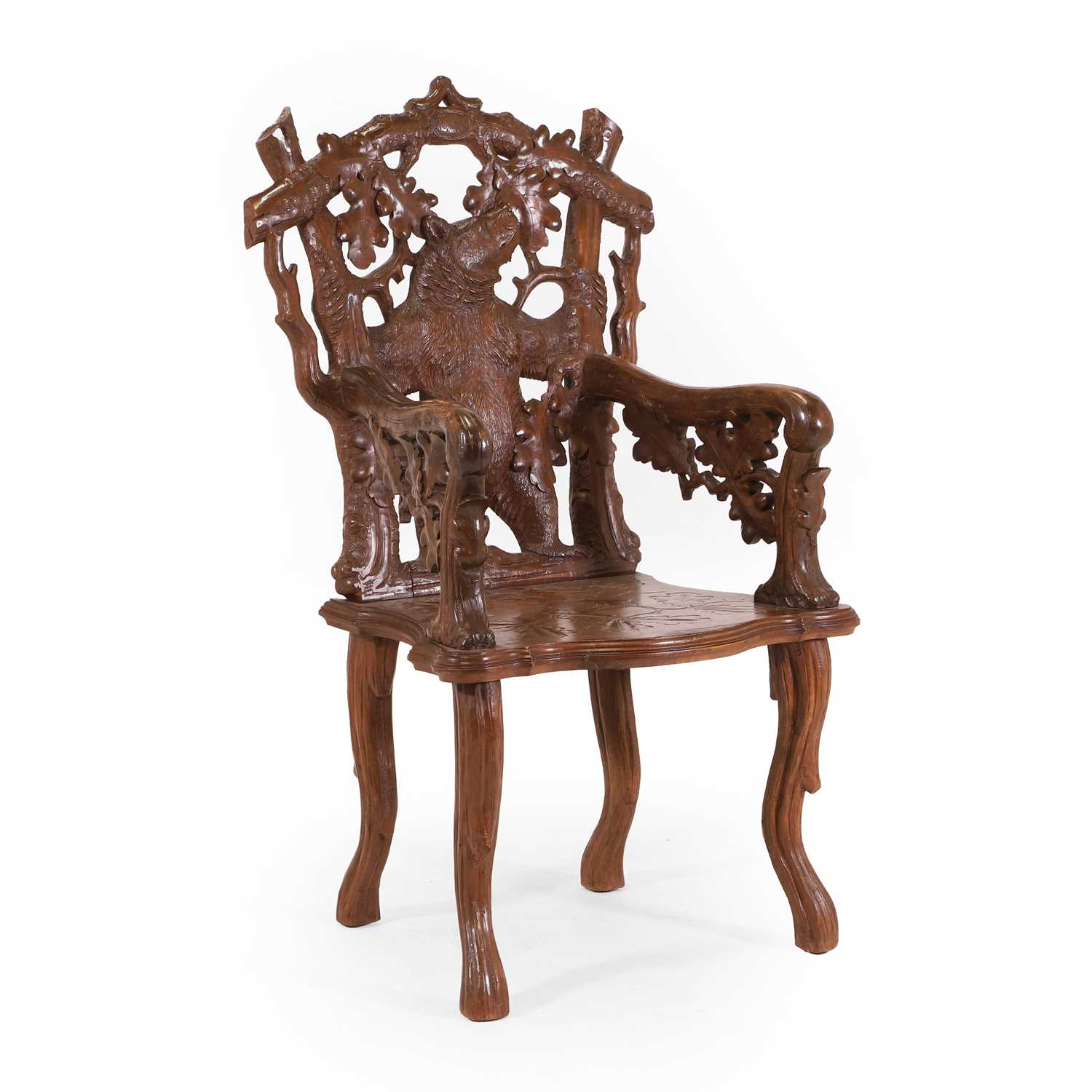Lot 83 - A carved linden wood Black Forest armchair