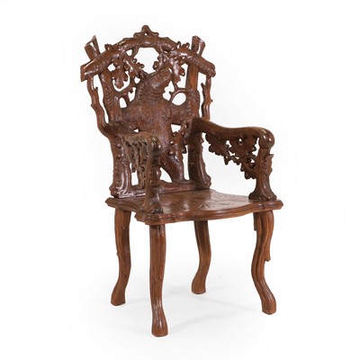 Lot 83 - A carved linden wood Black Forest armchair