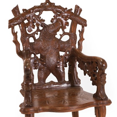 Lot 83 - A carved linden wood Black Forest armchair
