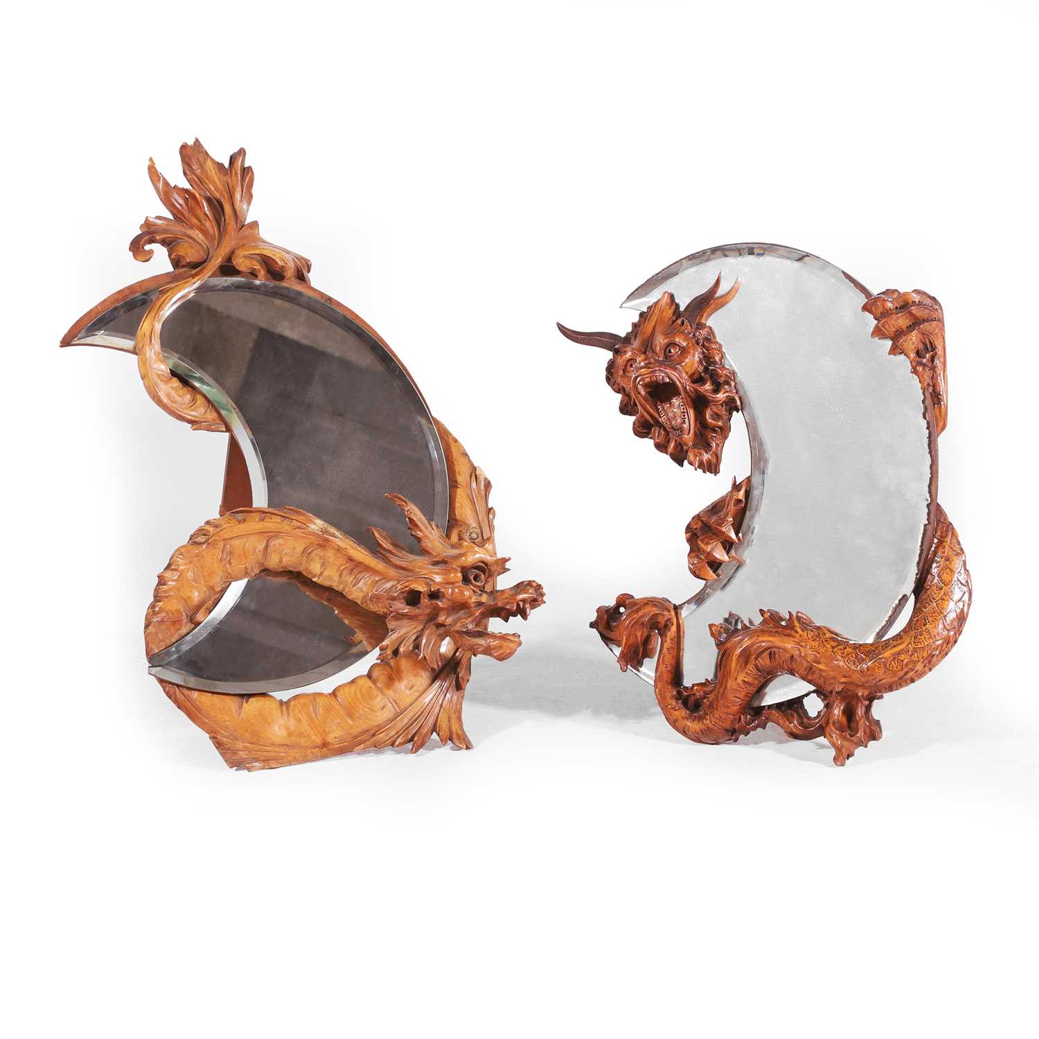 Lot 31 - A pair of carved walnut duelling-dragon mirrors in the manner of Gabriel-Frederic Viardot