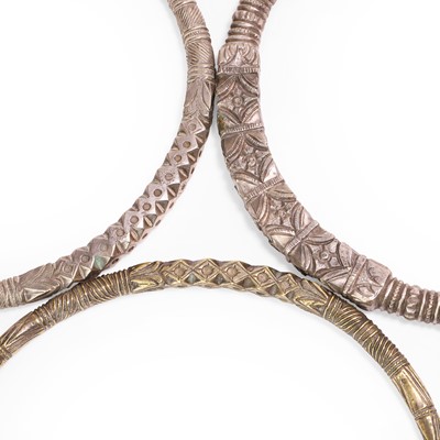 Lot 133 - Three metal torques