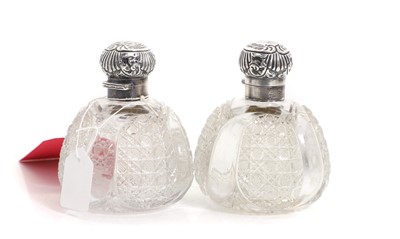 Lot 34 - A pair of cut glass and silver collared scent bottles