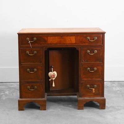 Lot 504 - A George III mahogany kneehole desk