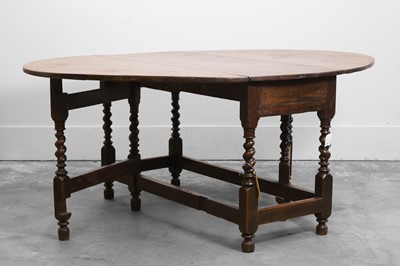 Lot 532 - An oak gateleg dining table