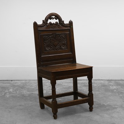 Lot 531 - A carved oak panel-back chair