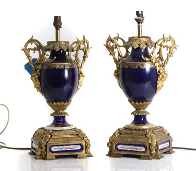 Lot 485 - A pair of gilt-metal mounted porcelain table lamps