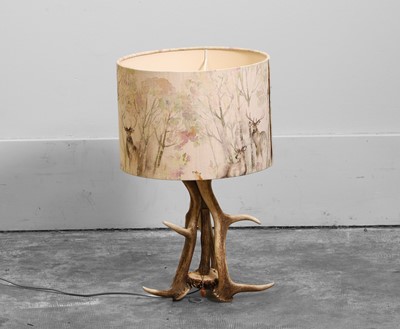 Lot 480 - An antler table lamp with stag-print shade