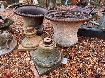 Lot 557 - A pair of cast iron urns