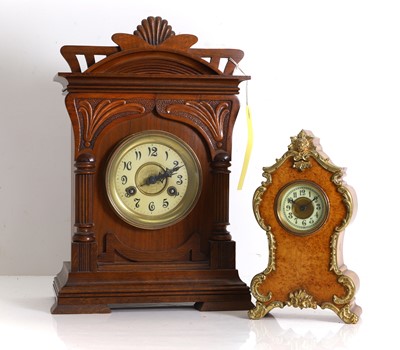 Lot 202 - A carved walnut mantel clock