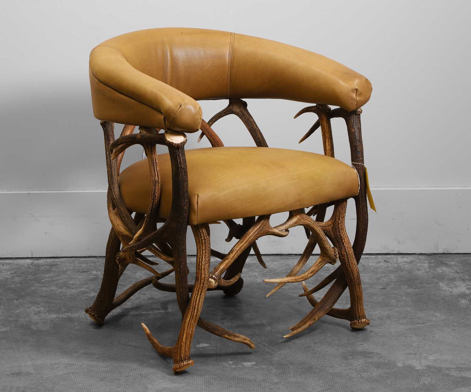 Lot 545 - An antler and leather armchair