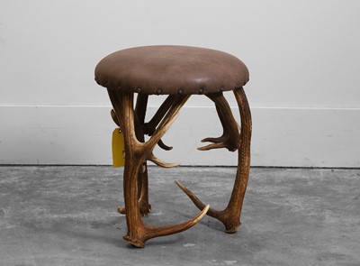 Lot 547 - A deer-antler leather stool