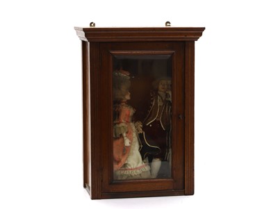 Lot 337 - Two regal dolls housed in a walnut cabinet