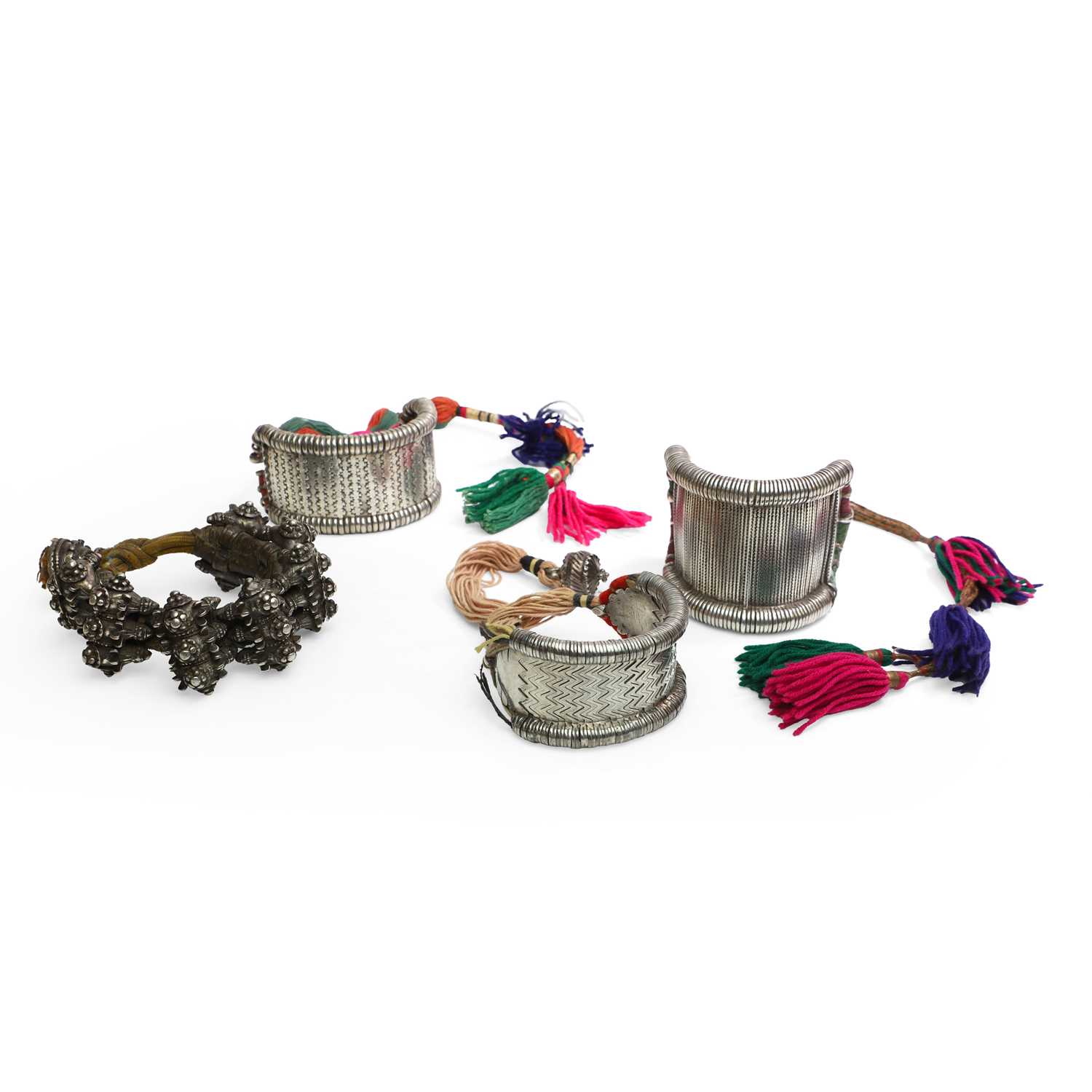 Lot 95 - Four reticulated silver bazuband armbands