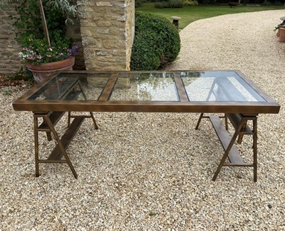 Lot 528 - A brass and glass desk