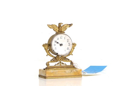 Lot 201 - A gilt metal and glass timepiece