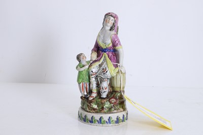Lot 101 - A pearlware figure group of the Widow of Zarephath