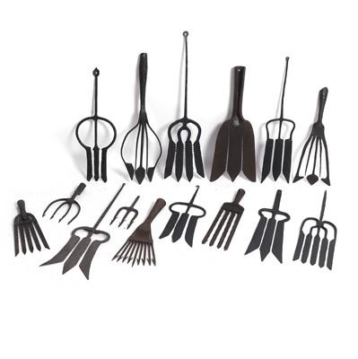 Lot 215 - A group of fifteen wrought-iron eel gleaves