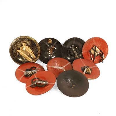 Lot 73 - A group of nine black-lacquered Samurai 'jingasa' hats