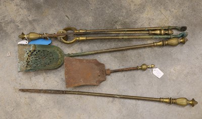 Lot 525 - A set of three brass fire implements