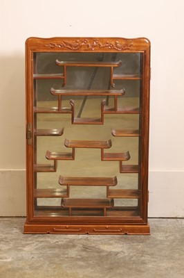 Lot 58 - A Chinese hardwood deity display cabinet