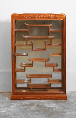 Lot 58 - A Chinese hardwood deity display cabinet
