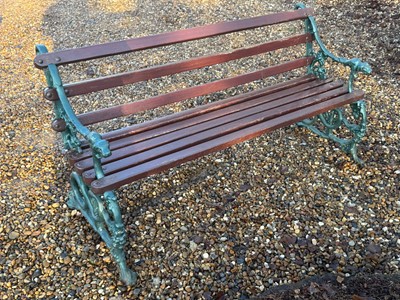 Lot 551 - A cast iron and painted garden bench