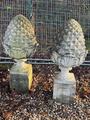 Lot 559 - A pair of reconstituted pineapple finials