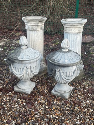 Lot 560 - A pair of reconstituted garden urns and covers