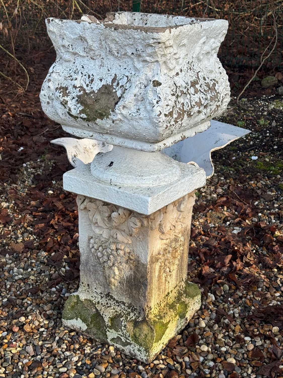 Lot 555 - A composite garden urn and stand