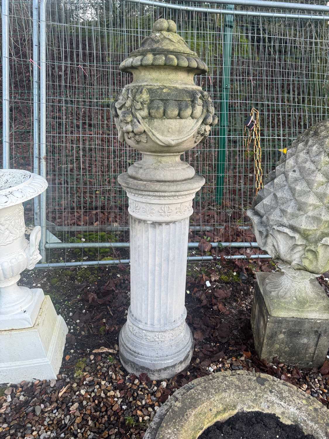 Lot 558 - A reconstituted garden urn and cover