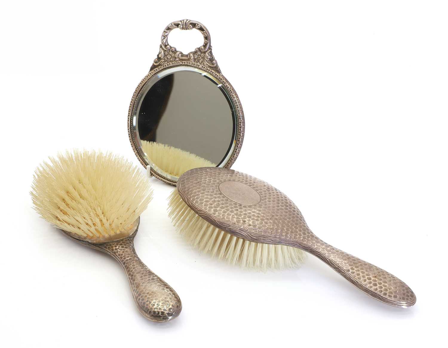 Lot 26 - A matched silver-backed dressing mirror and a pair of brushes