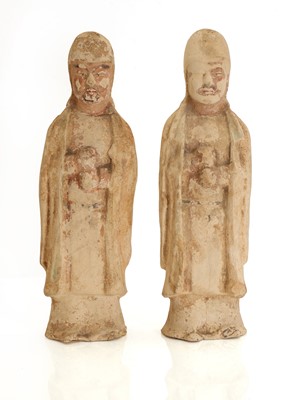 Lot 61 - A pair of Chinese pottery attendant figures